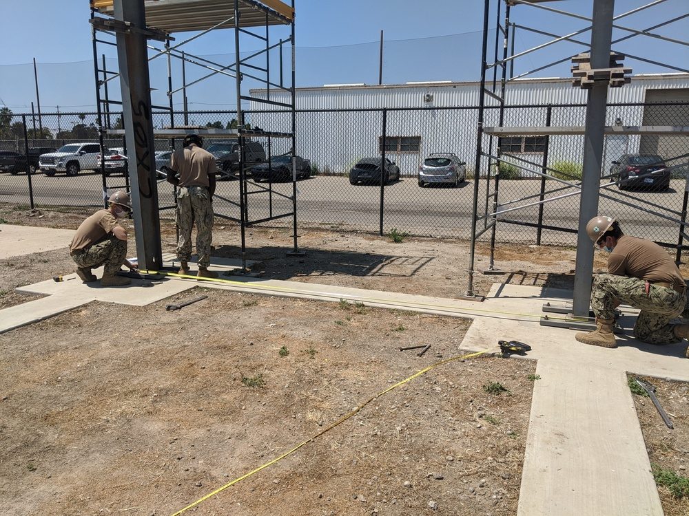 Construction crew assembling a pre-engineered building frame